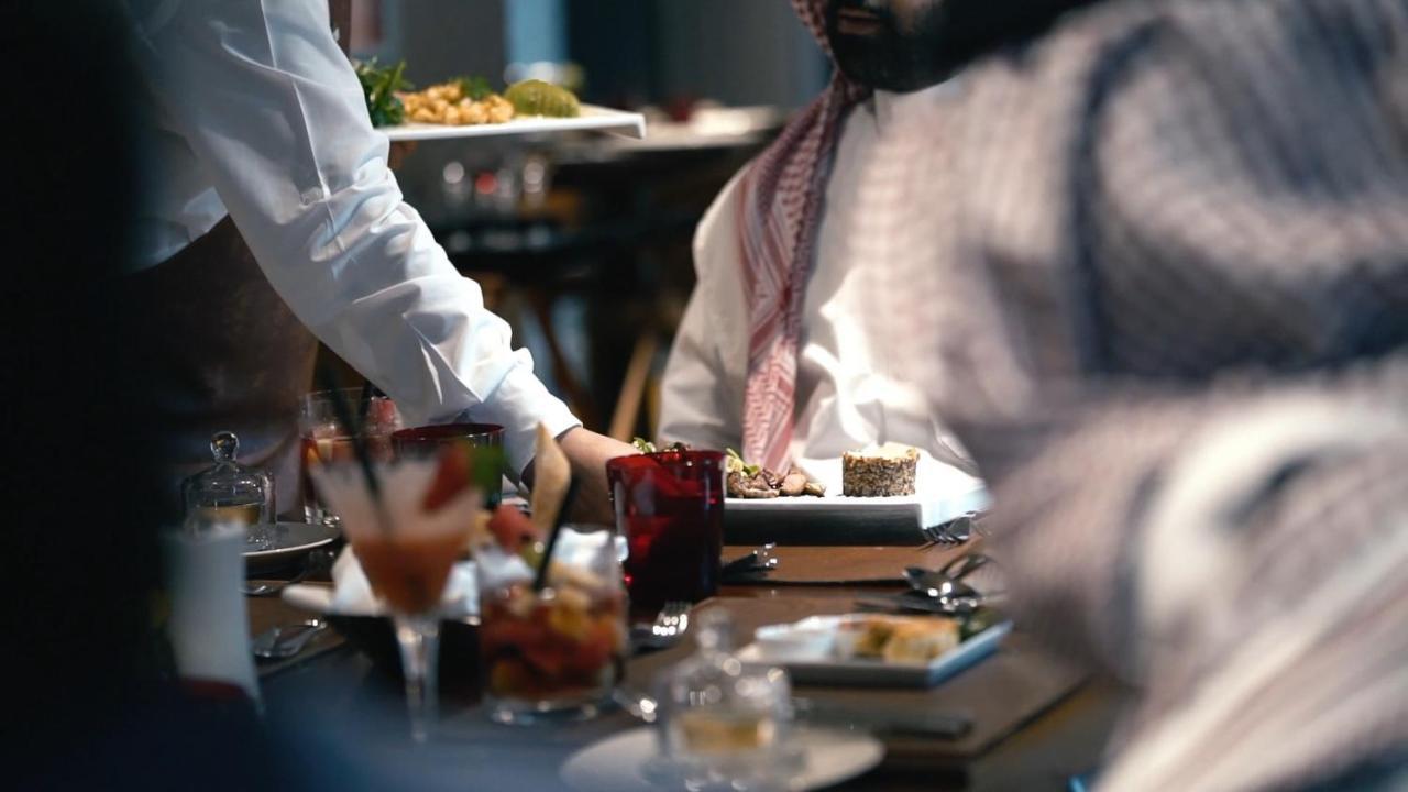 The Hotel Galleria Jeddah, Curio Collection By Hilton Exterior photo A waiter serving food